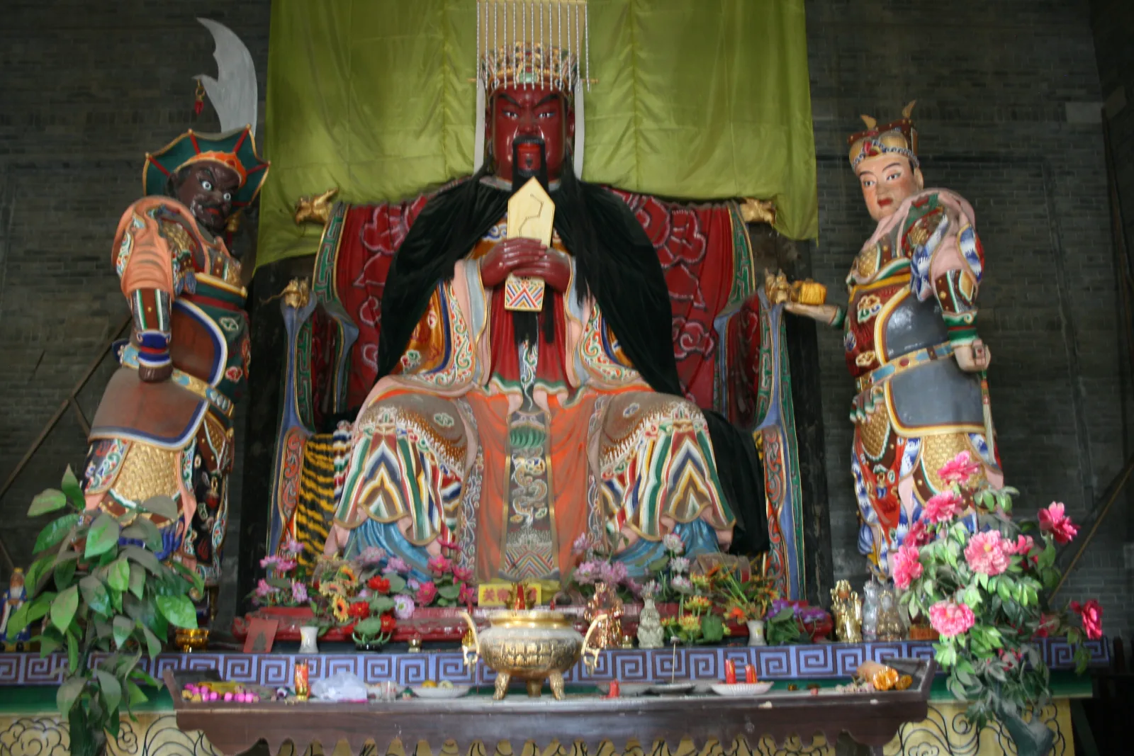 Seated Guan Yu figure in a historical merchants hall in southern Henan