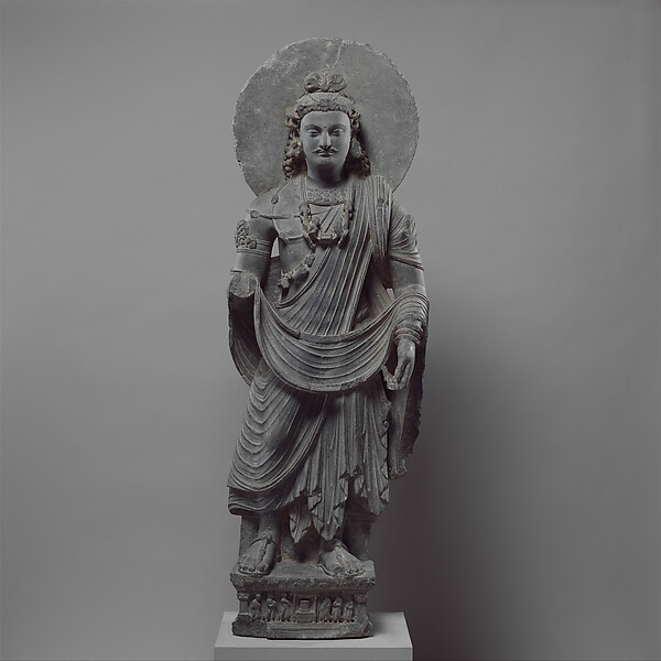 Third-century Gandharan standing bodhisattva Maitreya in princely dress with a water flask