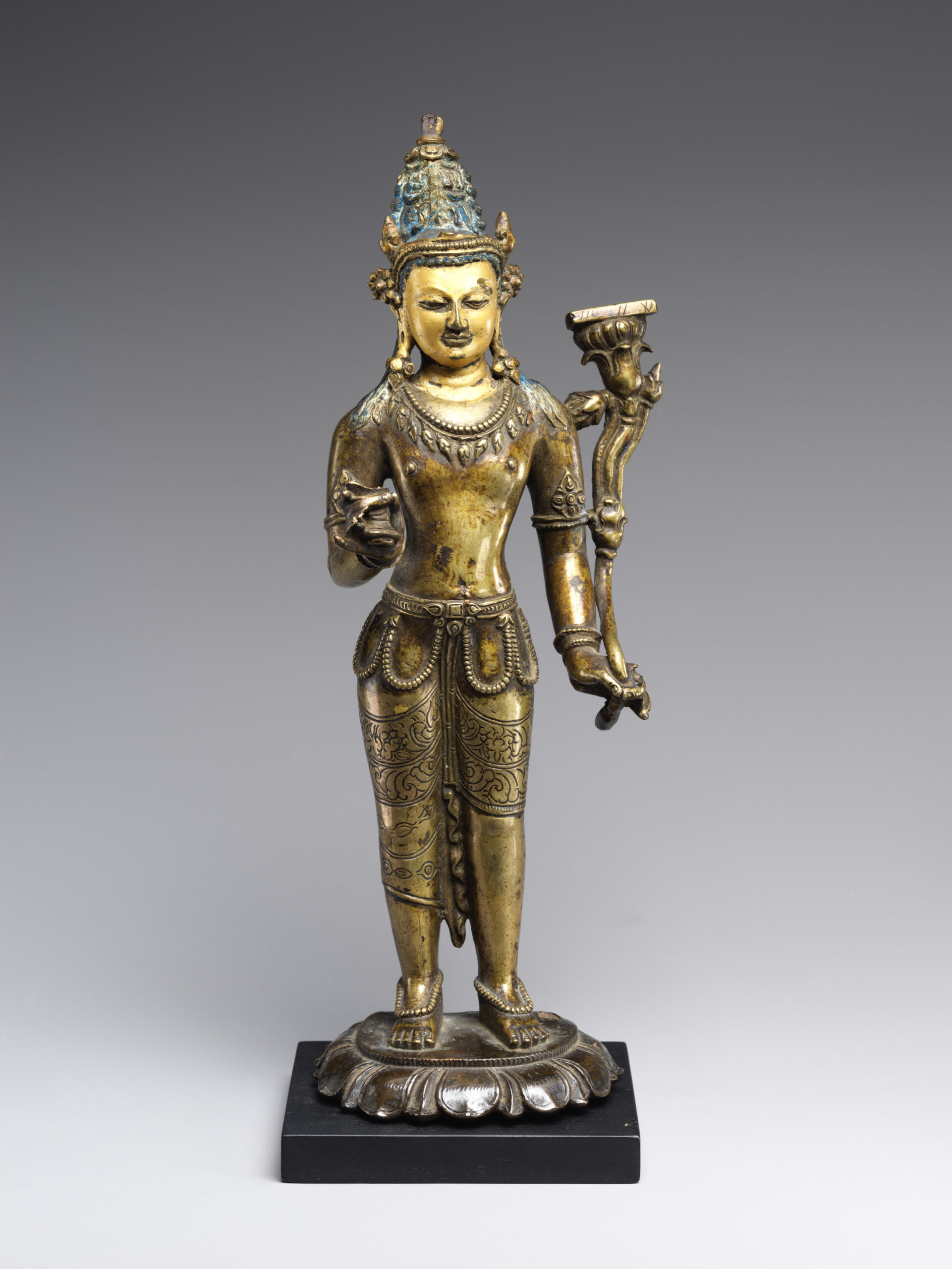 Twelfth-century Tibetan brass Manjushri with a manuscript on a lotus and the surviving hilt of a missing sword