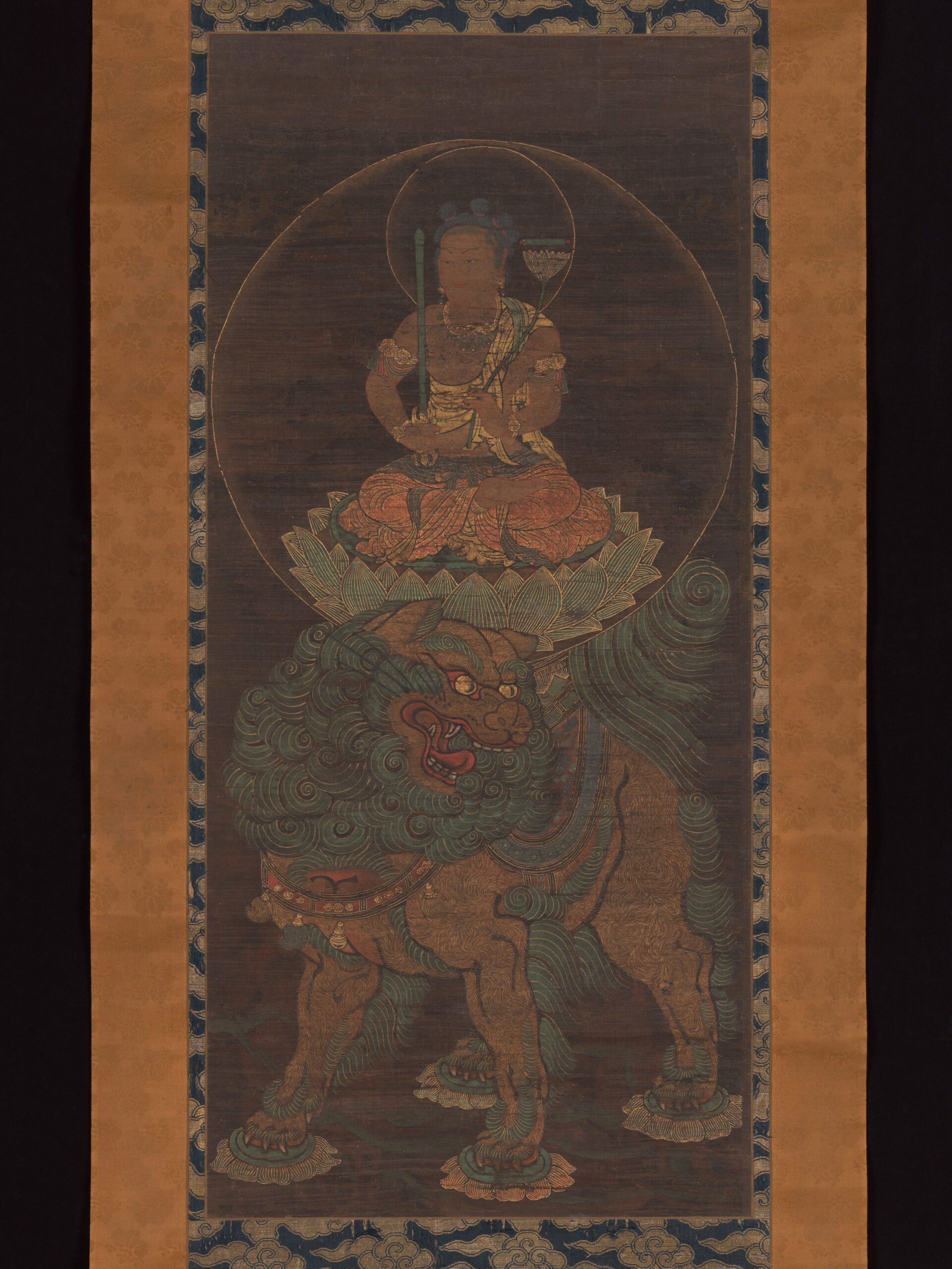 Fourteenth-century Japanese painting of Monju with five topknots seated above a lion with sword and sutra scroll